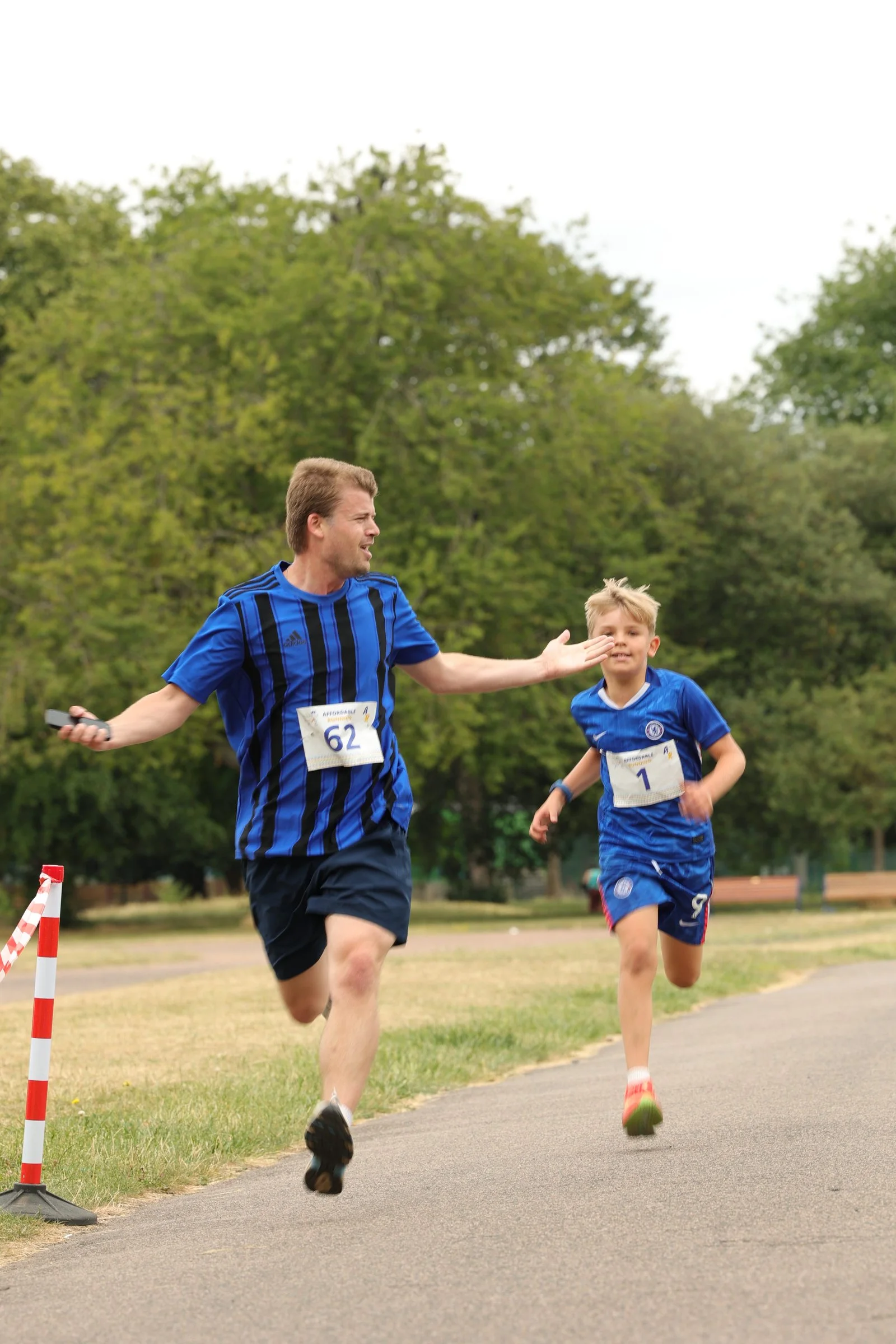 Two family members racing toward the finish together